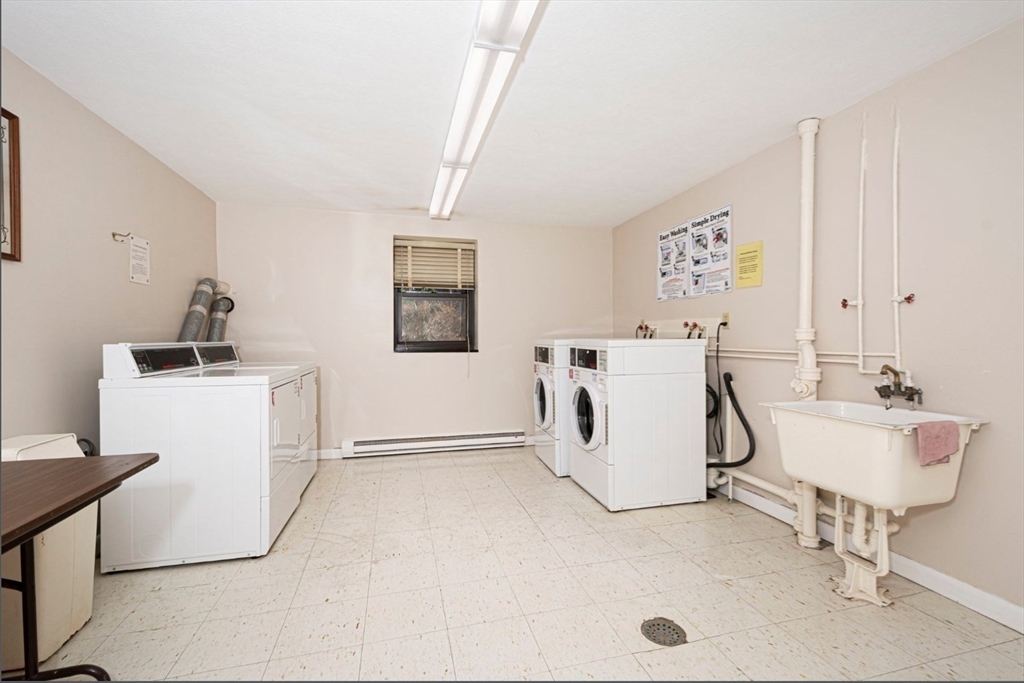 1325 Worcester Road, Unit A11 Framingham, MA 01701 - Photo 12 of 18 a utility room with cabinets dryer and washer