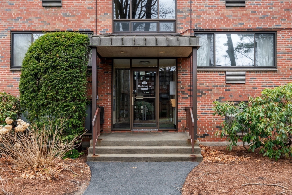 1325 Worcester Road, Unit A11 Framingham, MA 01701 - Photo 2 of 18 a front view of a house with a garden