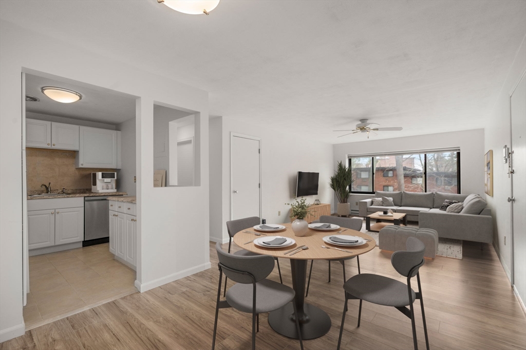 1325 Worcester Road, Unit A11 Framingham, MA 01701 - Photo 3 of 18 a open dining room with furniture and wooden floor