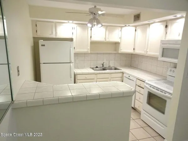 a kitchen with a sink cabinets and appliances