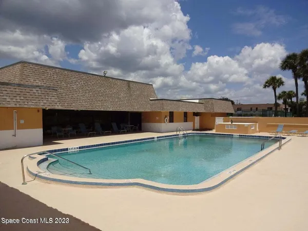 a view of a swimming pool with a yard