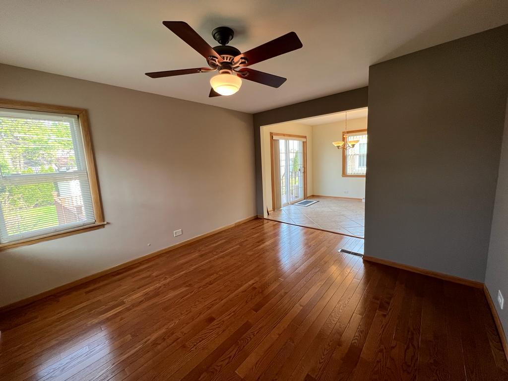 4031 Custer Avenue Lyons, IL 60534 - Photo 14 of 38 an empty room with wooden floor and windows