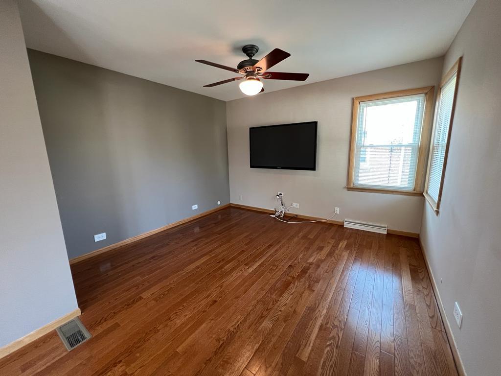 4031 Custer Avenue Lyons, IL 60534 - Photo 16 of 38 a view of a livingroom with wooden floor and a ceiling fan