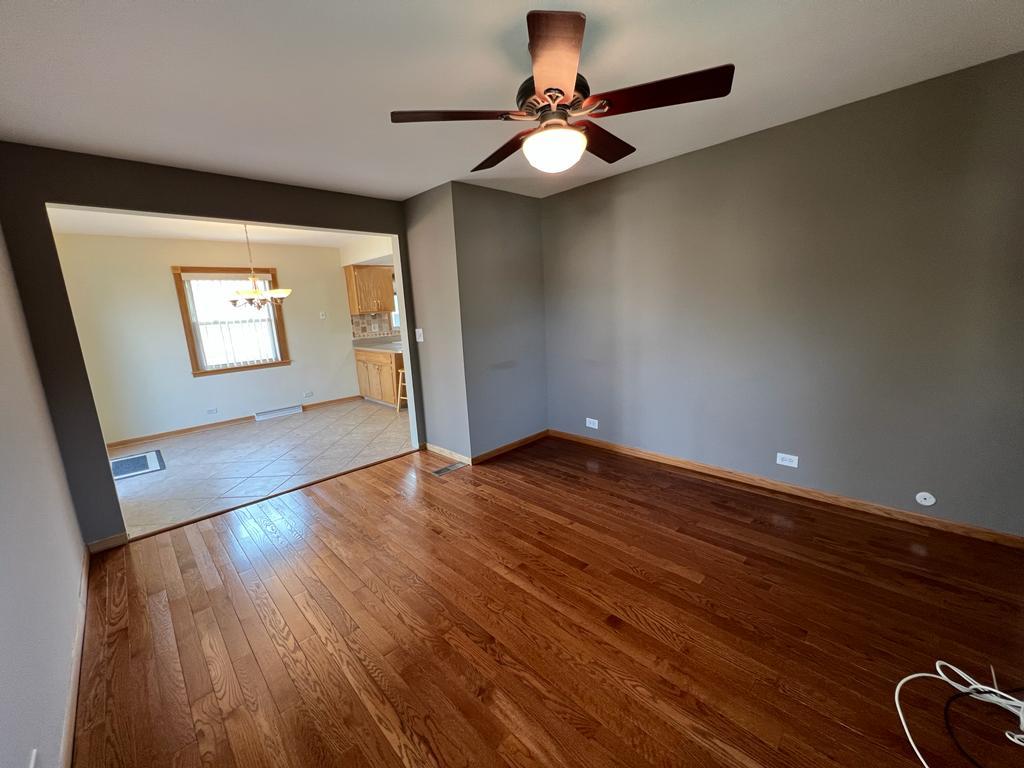 4031 Custer Avenue Lyons, IL 60534 - Photo 17 of 38 wooden floor in an empty room with a window