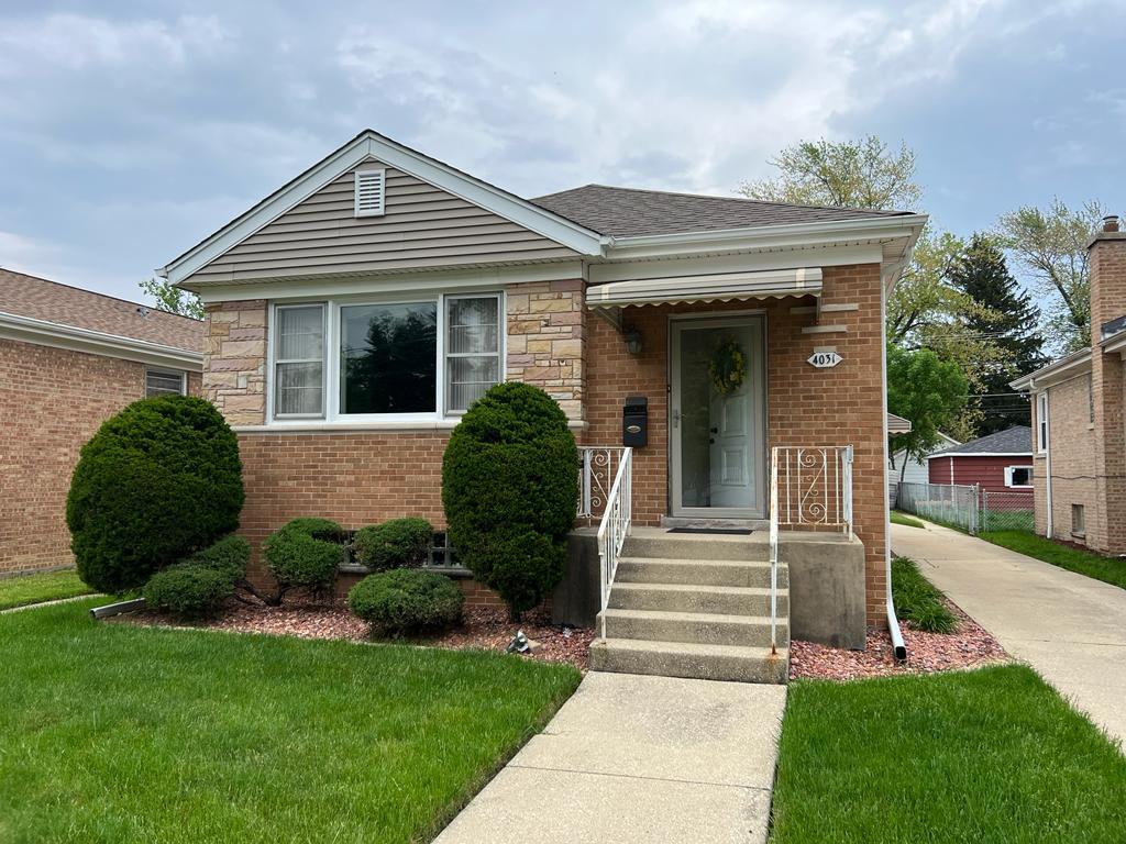 4031 Custer Avenue Lyons, IL 60534 - Photo 2 of 38 a front view of a house with a yard