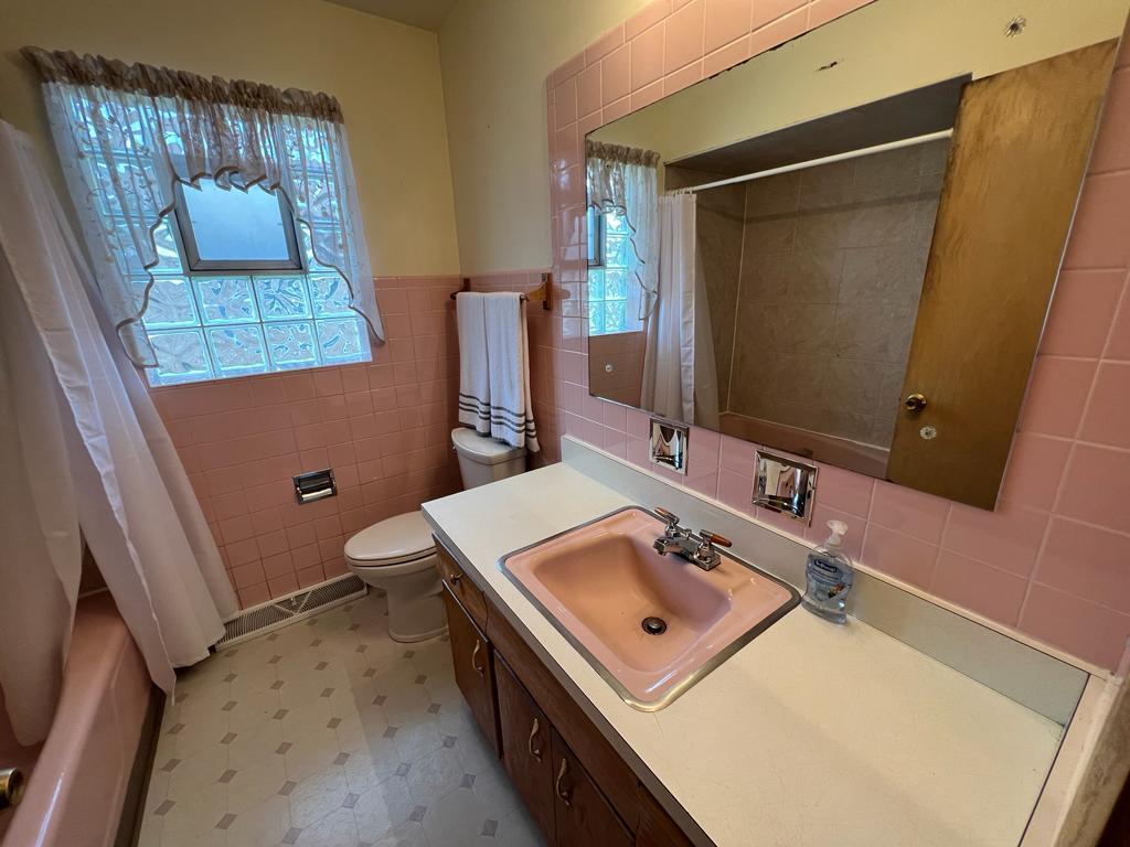 4031 Custer Avenue Lyons, IL 60534 - Photo 22 of 38 a bathroom with a sink toilet and mirror