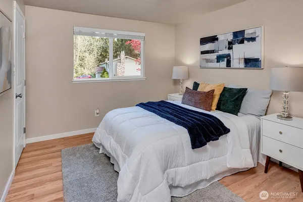 a bedroom with a bed and a window