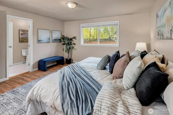 a bedroom with a bed lamp and a window