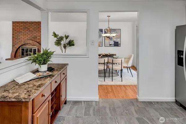 a view of a kitchen with kitchen island a counter top space and a stove