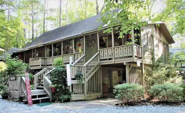 a front view of a house with plants and entryway