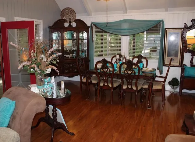 a view of a dining room with furniture and wooden floor