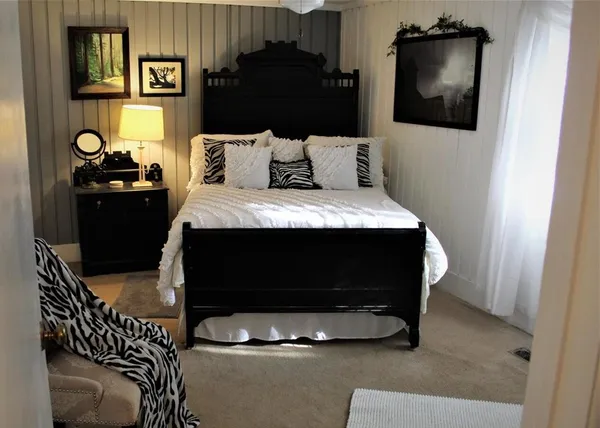 a bedroom with a bed and a dresser