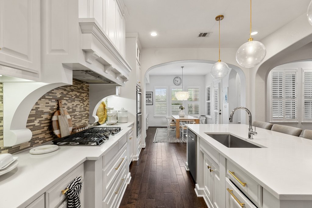 8801 Wild Rice Cove Austin, TX 78738 - Photo 14 of 40 A custom vent hood over the cooktop blends seamlessly with the cabinetry.