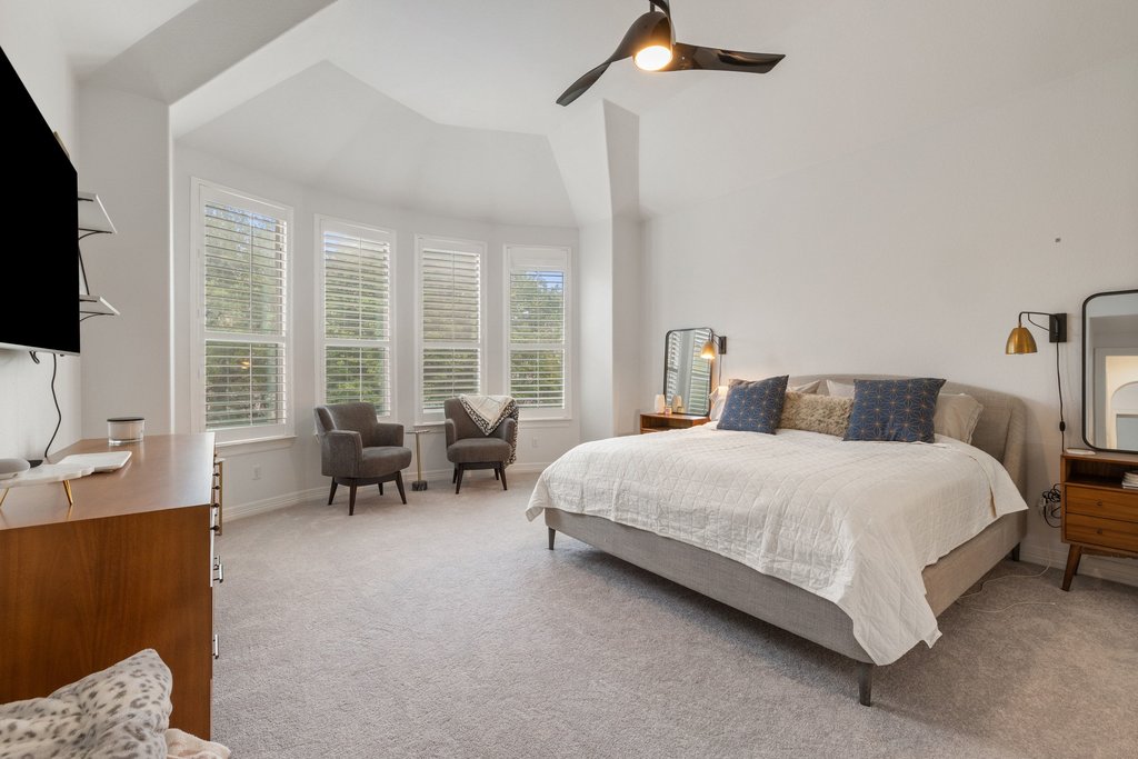 8801 Wild Rice Cove Austin, TX 78738 - Photo 18 of 40 The secluded main floor primary suite is an oversized retreat with beautiful bay windows overlooking the backyard.
