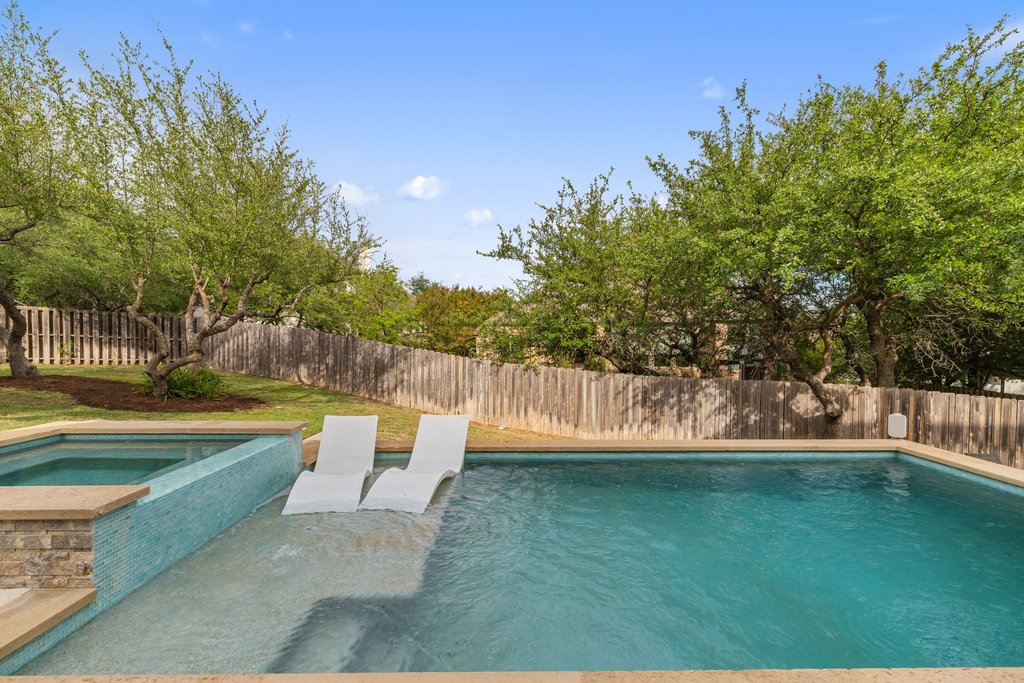 8801 Wild Rice Cove Austin, TX 78738 - Photo 37 of 40 The gorgeous pool comes with a wet lounge area and an attached spa for soaking under the stars.