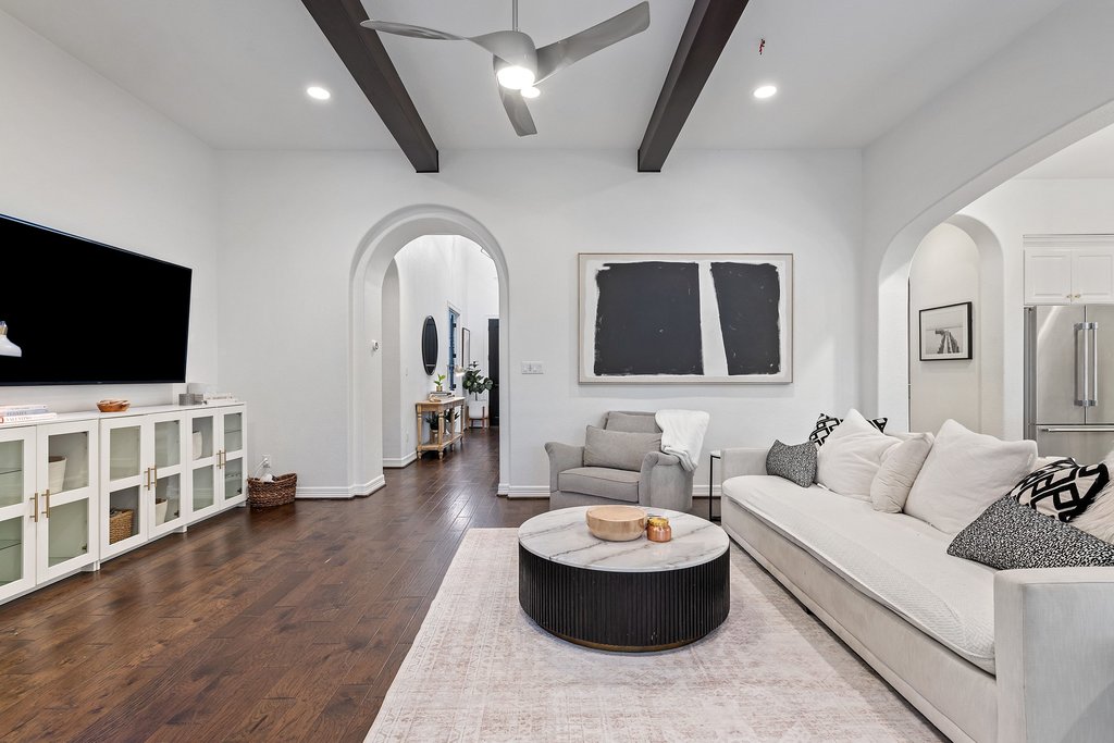 8801 Wild Rice Cove Austin, TX 78738 - Photo 7 of 40 The foyer flows into the main living area with gorgeous hardwoods, tall beamed ceilings, and a modern ceiling fan.
