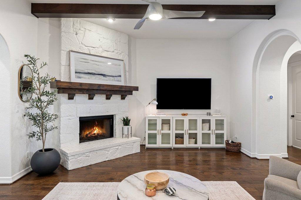 8801 Wild Rice Cove Austin, TX 78738 - Photo 9 of 40 The living room centers around a painted stone fireplace with a smooth wood mantel.