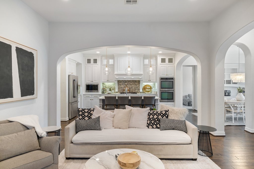 8801 Wild Rice Cove Austin, TX 78738 - Photo 10 of 40 The kitchen unfolds under a sweeping archway, overlooking the living room for seamless connectivity.