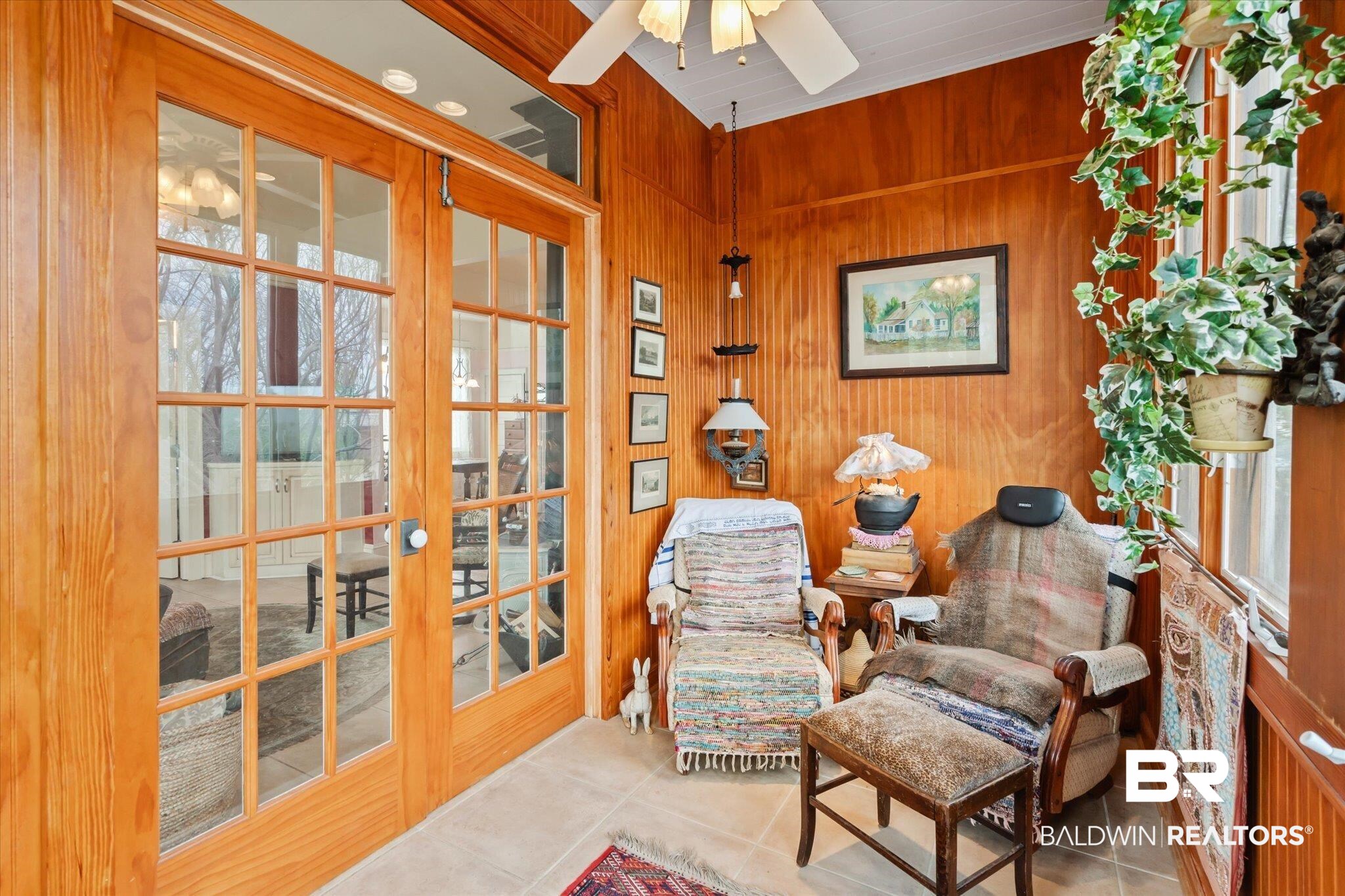12 Lebaron Street Mobile, AL 36602 - Photo 21 of 37 Living area with ceiling fan, wooden walls, french doors, and light tile patterned floors