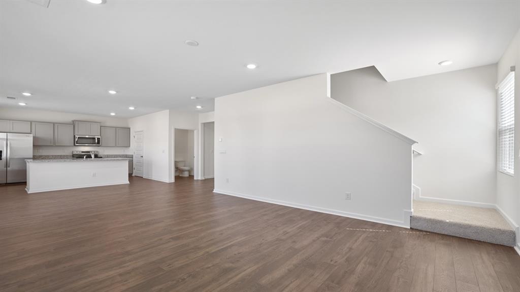8580 Seabiscuit Road Lithonia, GA 30058 - Photo 13 of 37 a view of kitchen livingroom with wooden floor
