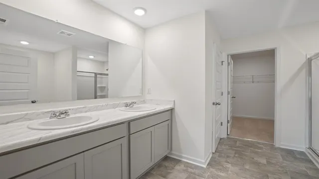 a bathroom with a sink double vanity and a mirror