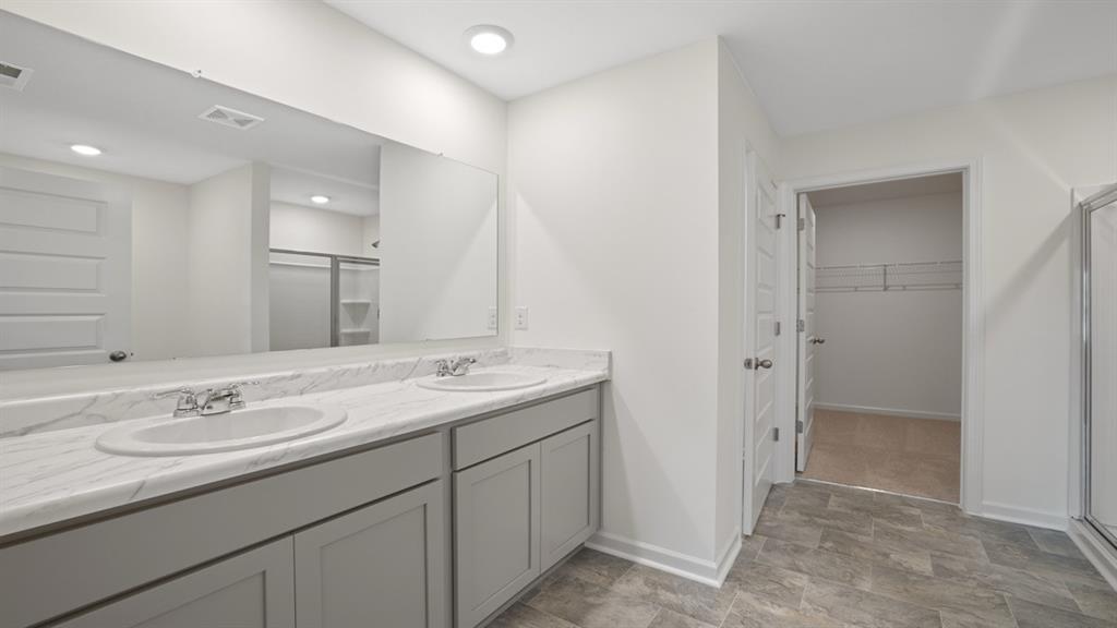 8580 Seabiscuit Road Lithonia, GA 30058 - Photo 17 of 37 a bathroom with a sink double vanity and a mirror
