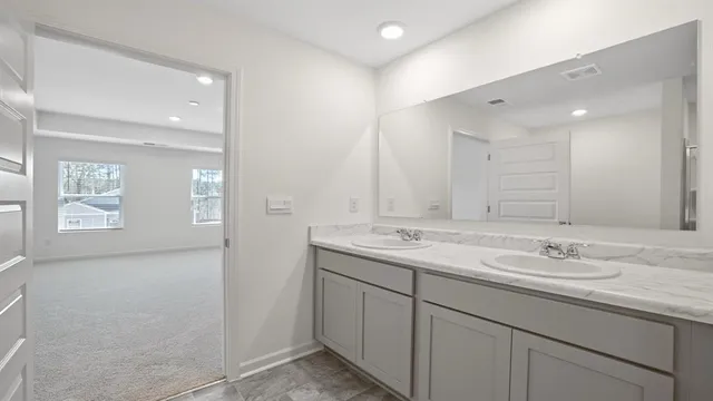 a bathroom with a granite countertop sink mirror and double