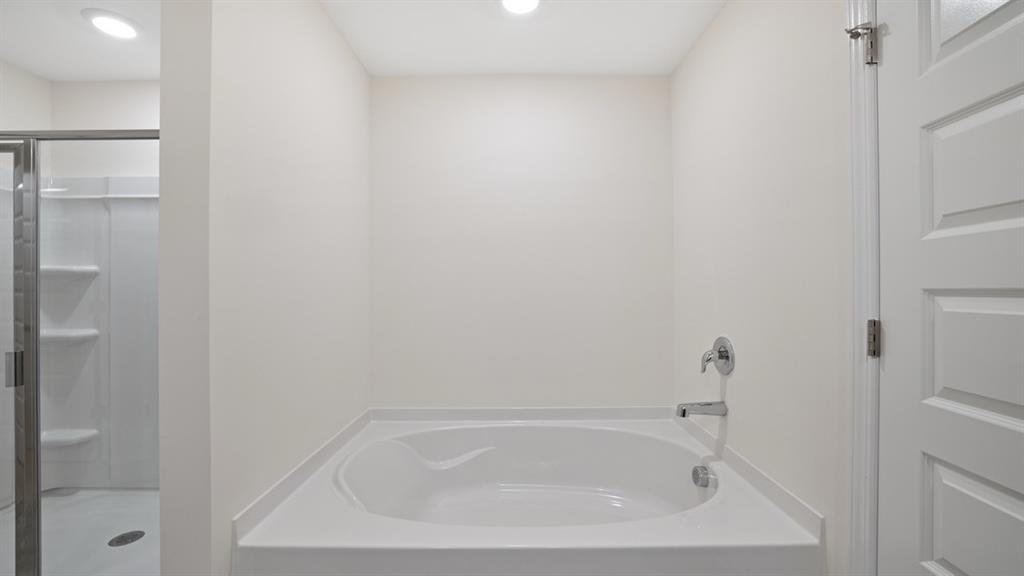 8580 Seabiscuit Road Lithonia, GA 30058 - Photo 19 of 37 a white bath tub sitting next to a white sink and vanity