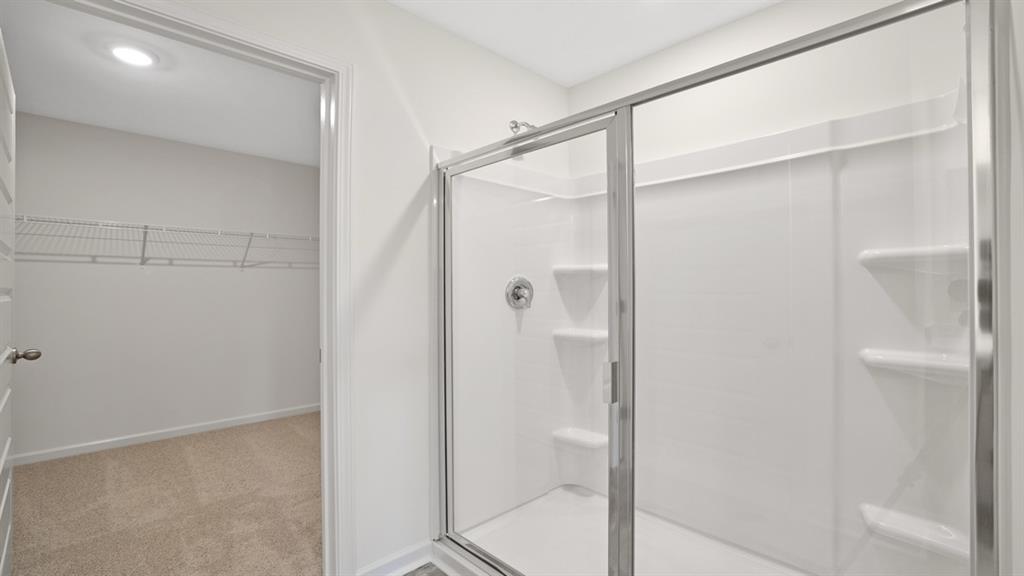 8580 Seabiscuit Road Lithonia, GA 30058 - Photo 20 of 37 a bathroom with a glass shower door