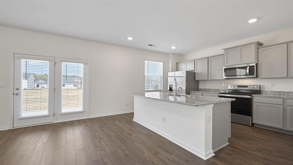 8580 Seabiscuit Road Lithonia, GA 30058 - Photo 3 of 37 a kitchen with stainless steel appliances granite countertop a sink stove and refrigerator