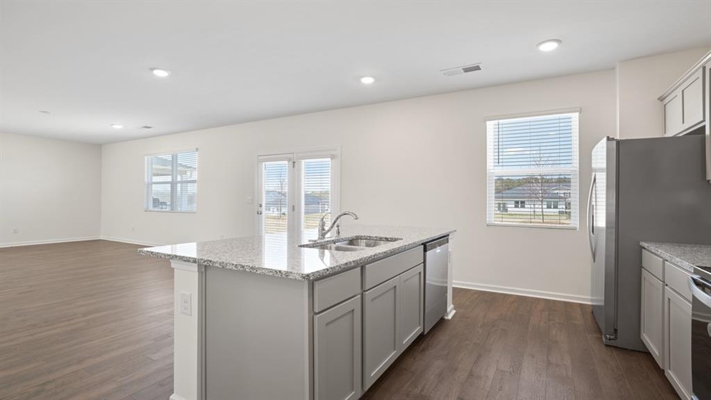 8580 Seabiscuit Road Lithonia, GA 30058 - Photo 6 of 37 a kitchen with stainless steel appliances granite countertop a sink stove and refrigerator