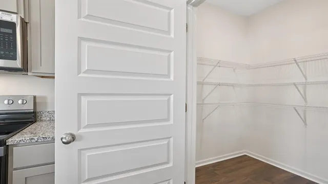 a view of walk in closet with empty racks