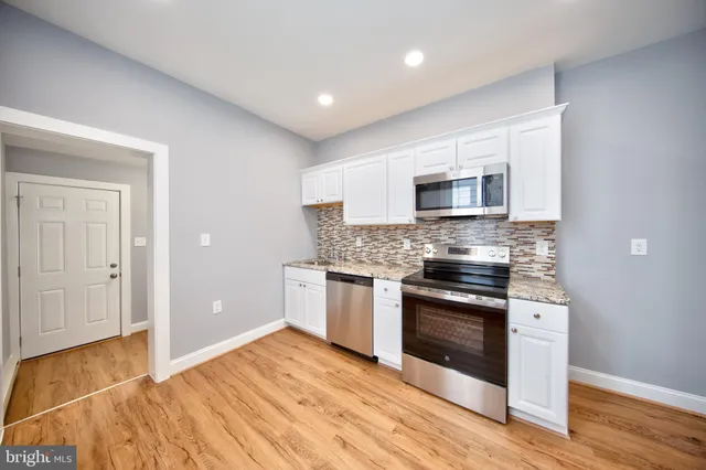 a kitchen with a stove a sink and a microwave