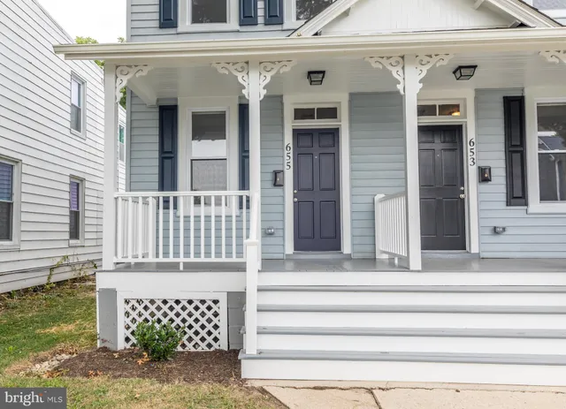 a front view of a house with a fence