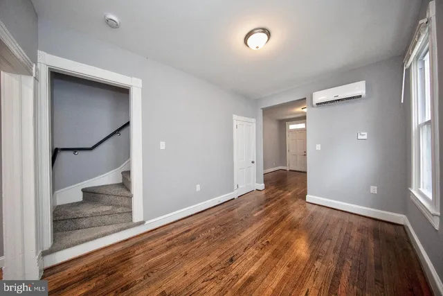 wooden floor in an empty room with a window