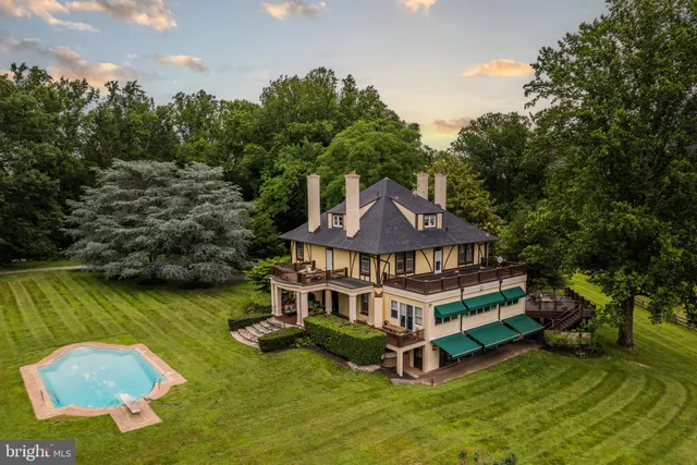 an aerial view of a house with swimming pool garden view and lake view