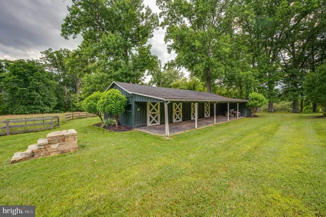 a view of a house with a backyard porch and sitting area