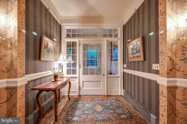 a living room with furniture a chandelier and a fireplace