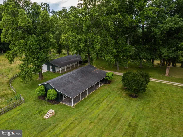 a living room with furniture a fireplace and a large window