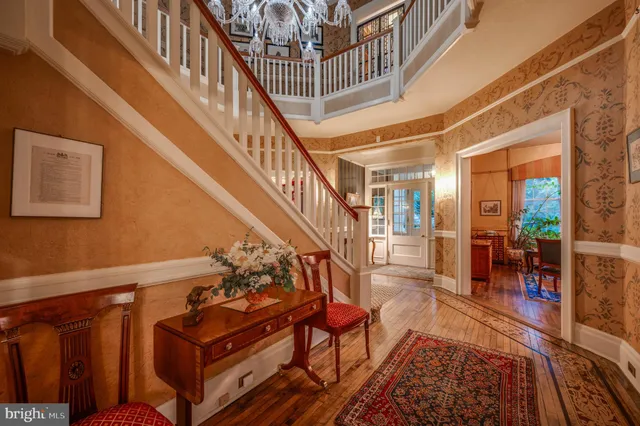 a living room with fireplace furniture and a chandelier