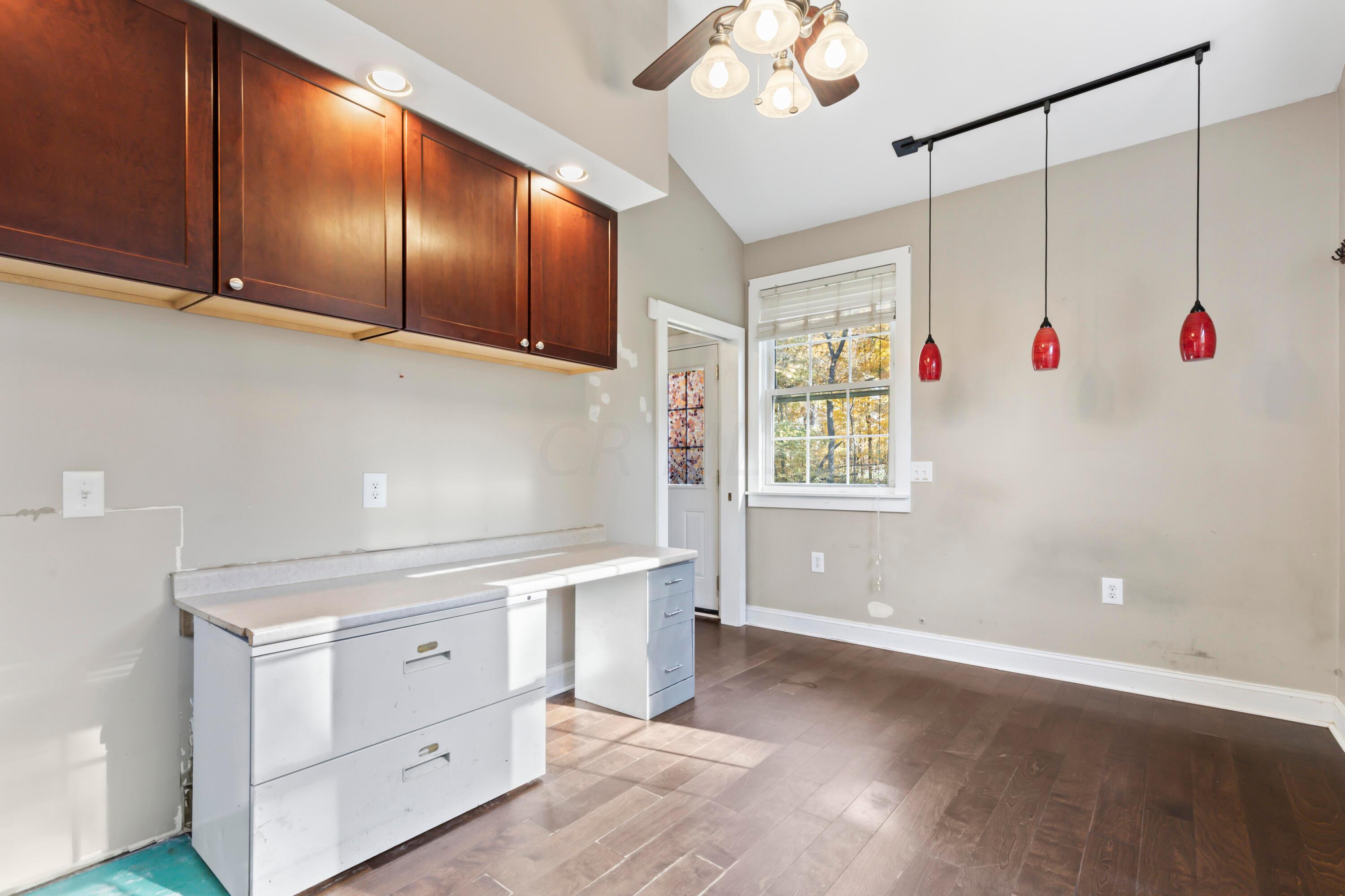 9495 Kilbourne Road Sunbury, OH 43074 - Photo 36 of 84 • New engineered hardwood
flooring May 2017
• Tan painted walls
• Lighted ceiling fan
• Coffered ceiling
• Window air conditioning
unit remains
• Wall cabinets
• Can lighting
• Door front walk/drive
• Built-in desk/counter
• Pendant lighting