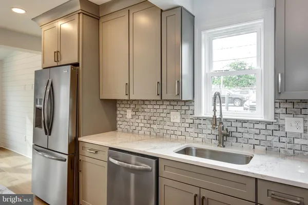 a view of a kitchen with a refrigerator and sink