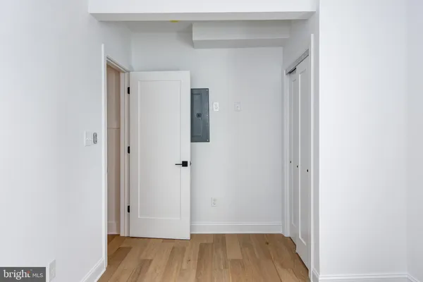 a view of a hallway with wooden floor