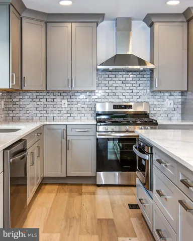 a kitchen with cabinets appliances and a sink