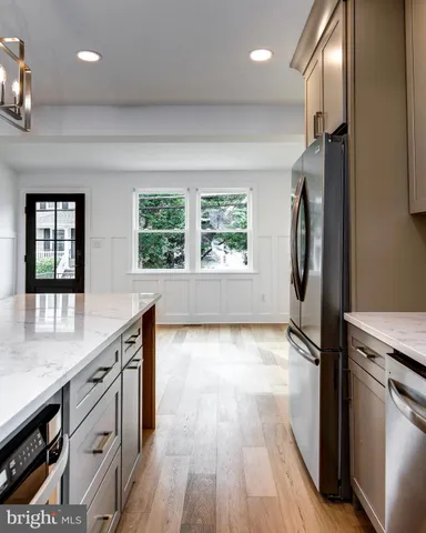 a kitchen with stainless steel appliances a refrigerator sink and stove