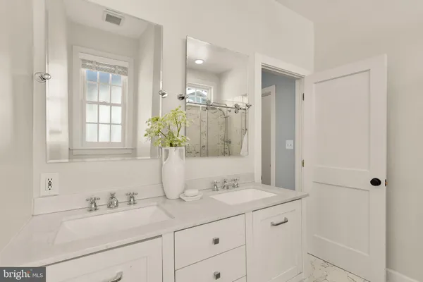 a bathroom with a sink double vanity and a mirror