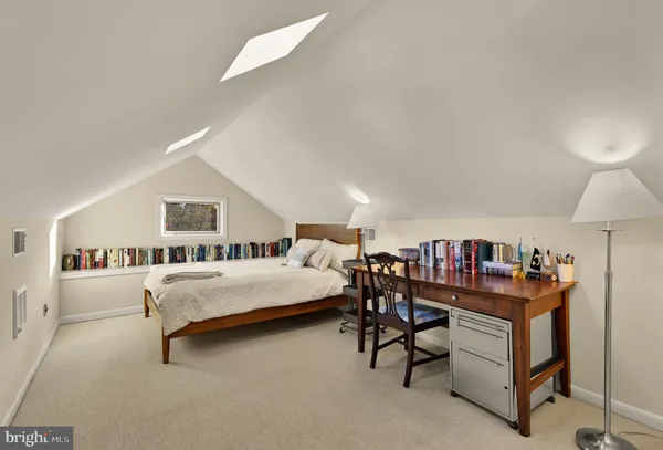 a bedroom with furniture and a book shelf