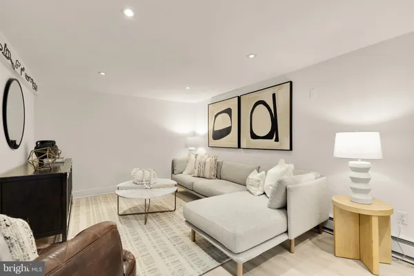 a living room with furniture and a lamp