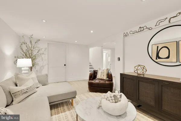 a living room with furniture and a mirror
