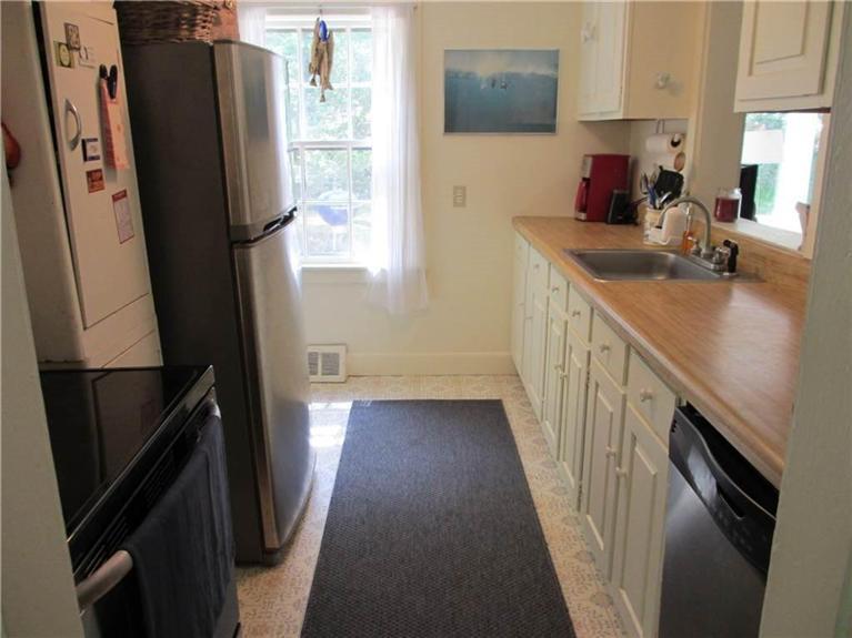 299 Gull Pond Road Wellfleet, MA 02667 - Photo 8 of 14 a kitchen with sink a refrigerator and a stove